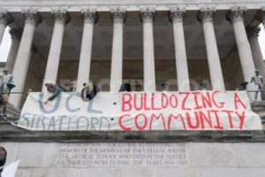 Protesters against the proposed UCL campus in Stratford occupy the Portico with a banner reading "UCL Stratford: bulldozing a community".