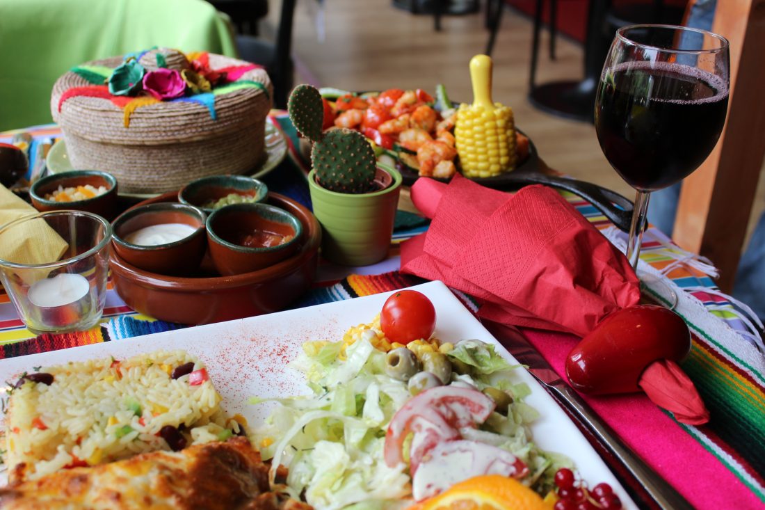 Dining table with platters of Mexican food