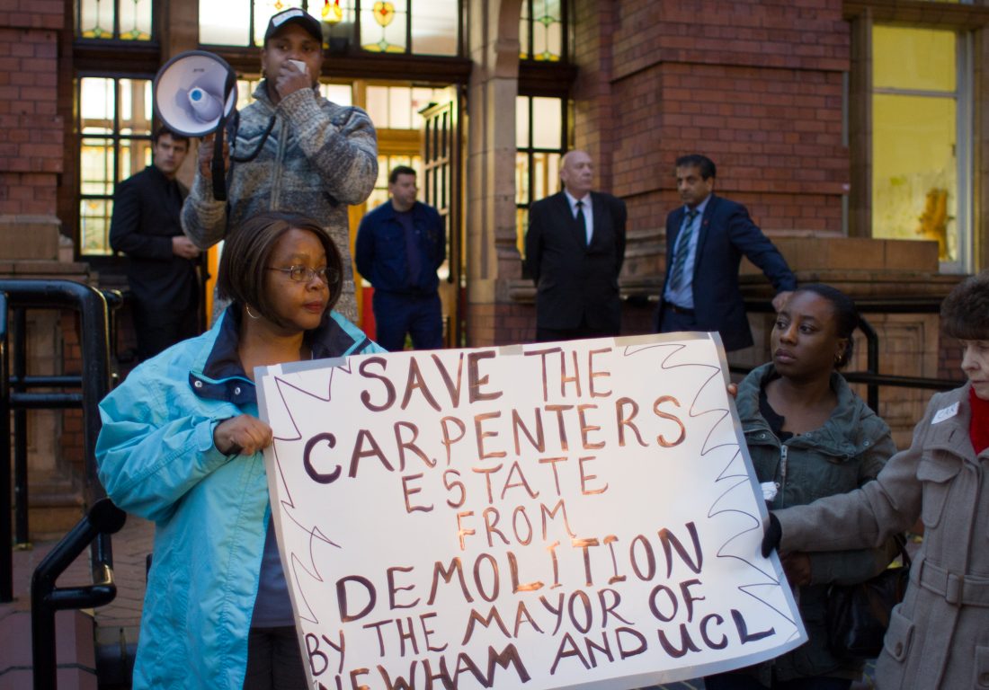 Carpenters residents protest outside Newham town hall, holding a banner which reads: "Save the Carpenters Estate from demolition by the Mayor of Newham and UCL".