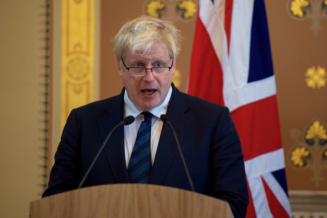 Boris Johnson, Foreign Secretary, speaks from behind a podium, in front of a Union flag, at a press conference in 2017